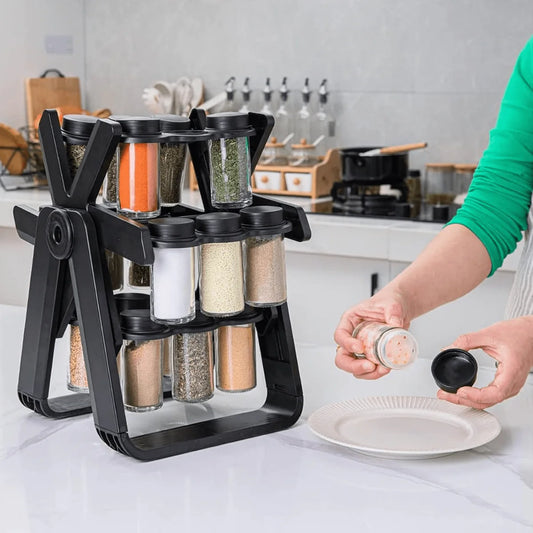 Black spice rack with various spices on a kitchen counter